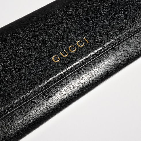 Wallet with strap and Gucci lettering